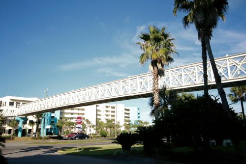 a white bridge over a street with palm trees at Destin West Gulfside 209 - You Own Slice of Paradise! - Ocean Views - Free Beach Service! in Fort Walton Beach