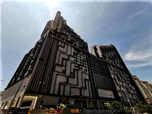 a tall building with a geometric design on it at Attic Home Melaka Imperio Residence & Jonker in Melaka
