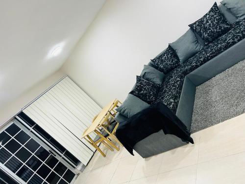 a living room with a chair and a couch at Paradise Apartment Suva in Suva