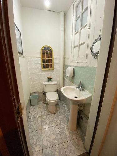 a bathroom with a toilet and a sink at Casa Argot in Santiago