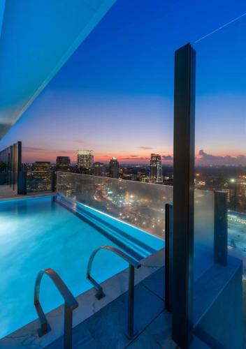 a swimming pool with a view of the city at night at Hanover BLVD Place in Houston