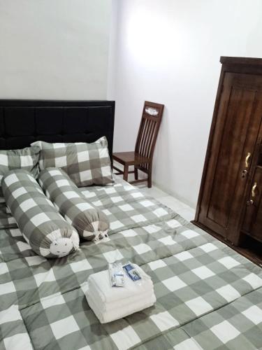 a bed with a stuffed animal laying on top of it at Liefly Prambanan Villa in Randugunting