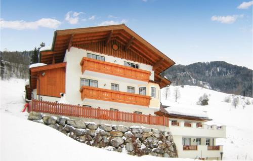 a building on top of a snow covered mountain at Haus Lindorfer Ferienwohnung in Grossarl