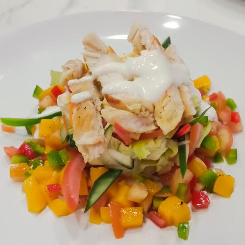 a plate of food with chicken and vegetables on it at Manarra Sea View Resort in Puerto Galera