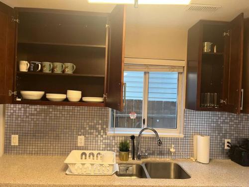 una cucina con lavandino e finestra di Spacious 2 bedroom suite a Port Coquitlam