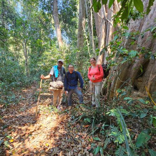 a group of people walking on a trail in the woods at Banlung Mountain View Treks & Tours in Banlung