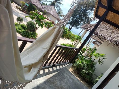 a hammock on the balcony of a resort at Sarana Bungalows in Baan Tai