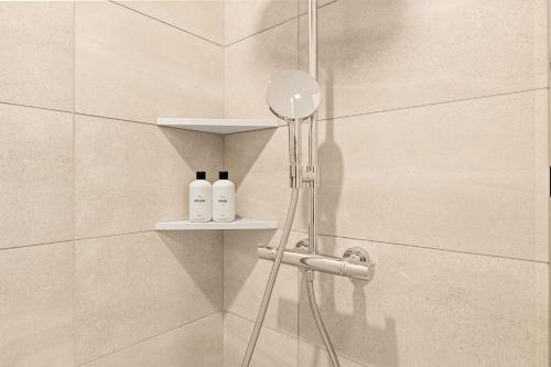 a shower with two bottles on a shelf in a bathroom at @ Marbella Lane - Luxe 3BR Penthouse in Long Beach in Long Beach