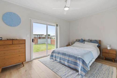 Un dormitorio con una cama y un reloj en la pared. en 57 Padman Crs Middleton -No Linen Included, en Middleton