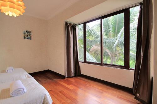 a room with a bed and a large window at A Tranquil Retreat Near PWTC & KLCC in Kuala Lumpur