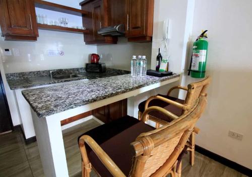a kitchen with a counter with a table and two chairs at Manarra Sea View Resort in Puerto Galera