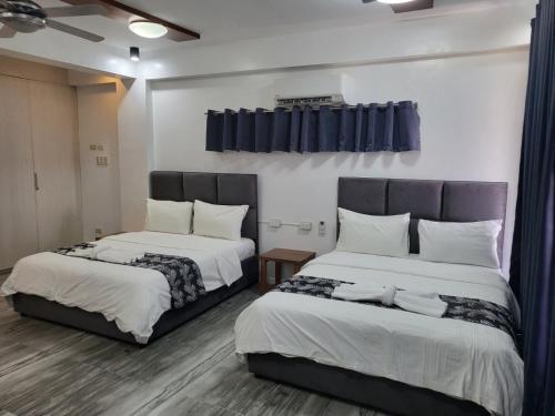 two beds sitting next to each other in a room at Manarra Sea View Resort in Puerto Galera