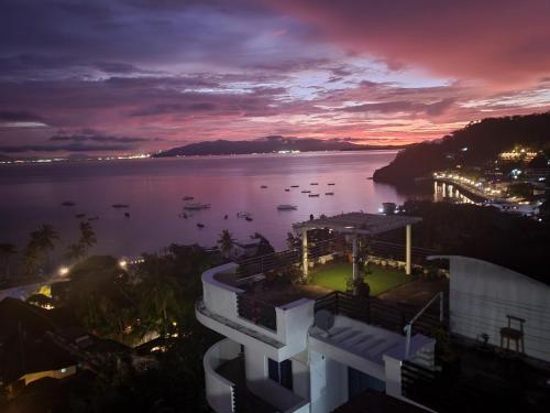 a view of a building with a view of the water at Manarra Sea View Resort in Puerto Galera