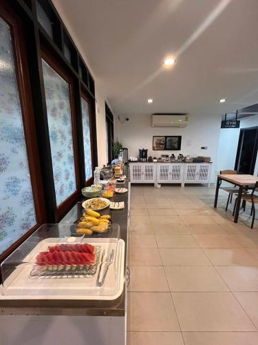 a buffet line with food on display in a restaurant at The Guest Hotel & Hostel in Chiang Mai