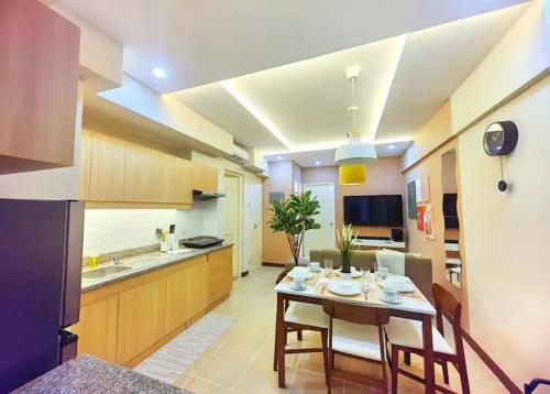a kitchen with a table and some chairs in a room at mushROOM Condotel at Infina Towers, Quezon City in Manila