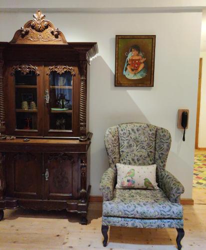 a chair and a cabinet in a room at Kudrat - A Boutique Homestay- Tirthan Valley in Banjār