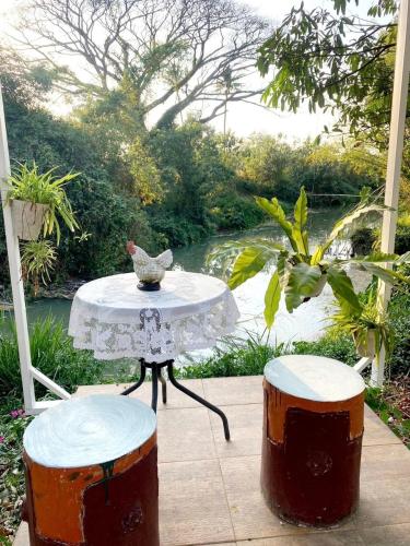 a table with a bird sitting on it next to two drums at Sleep Home Khaoyai in Pak Chong