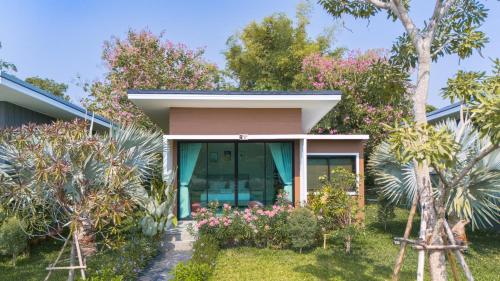 a house with pink flowers in front of it at SeeView Resort (ซีวิว รีสอร์ต) in Ban Pak Nam