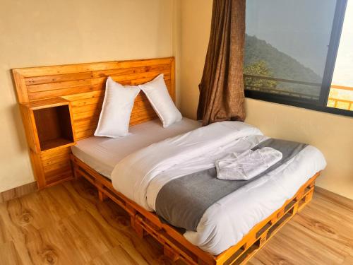 a bed in a room with a window at Mountain View cafe in Pokhara