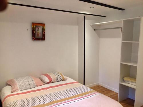 a bedroom with a bed and a closet at Manoir Le Rest in Lanrivain