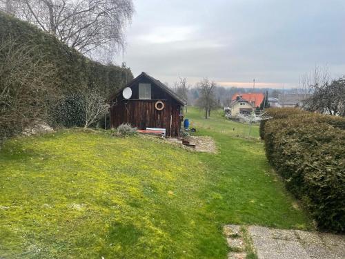 a small house on a grassy hill with a yard at Wohnen im ehemaligen Kloster in Schörfling am Attersee in Schörfling