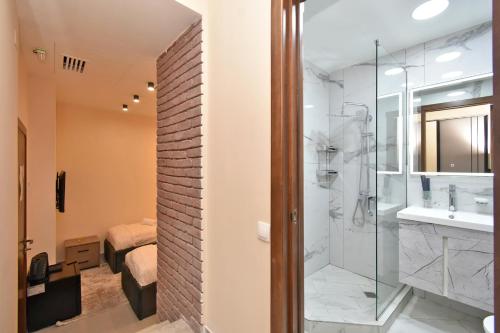 a bathroom with a shower and a sink at Avenue 23 Boutique Hotel in Yerevan