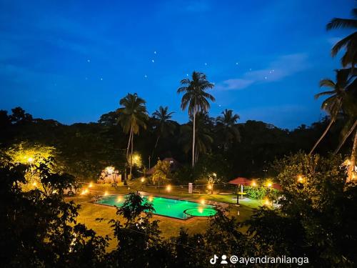 a view of a swimming pool at night at Crown Holiday Village near Marawila in Nattandiya
