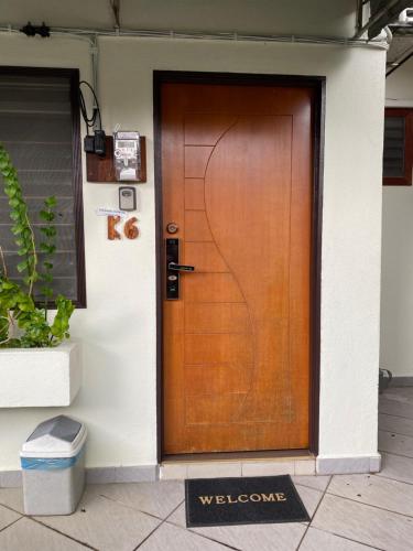 una puerta de madera en el lateral de un edificio en Cheras Homestay - Miharja Private room @ Sunway Velocity, en Kuala Lumpur