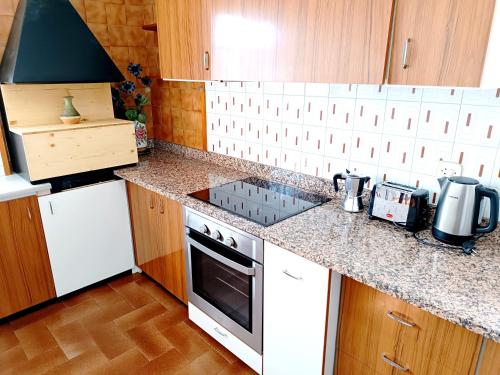 a kitchen with a stove and a counter top at Secrets of Montserrat in El Bruc