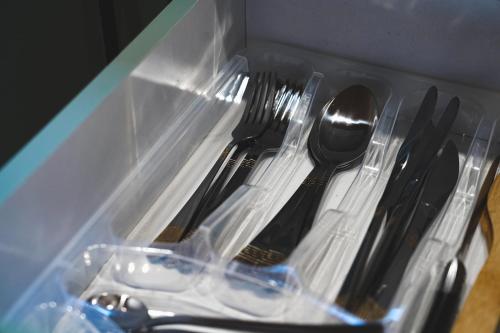 a plastic container with forks and spoons and forks and spoons at Sanseco Cottage in Stepantsminda