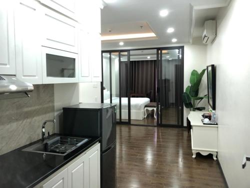 a kitchen with a sink and a kitchen with a bedroom at Khách sạn QUEENIE in Hai Phong