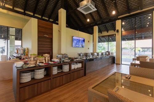 a restaurant with a counter with plates on it at Sea Sand Sun Hua Hin by JC Kevin Hotel & Resort in Phetchaburi