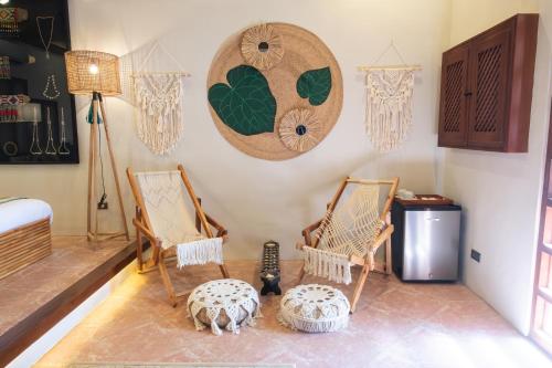 a room with two rocking chairs and a table at Nawa Wellness in Calatagan