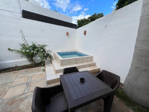 a patio with a table and a swimming pool at Hotel Casablanca 160 in Mérida