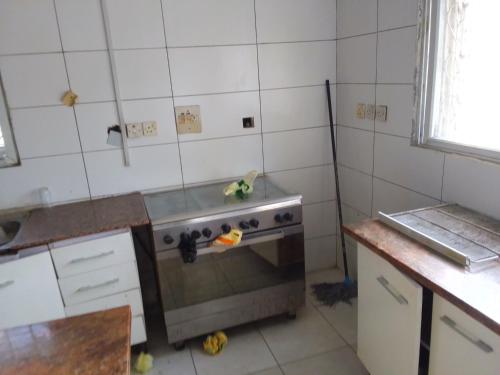 a kitchen with a stove and a sink in it at St Theresas apartment Lodge 3 in Lekki