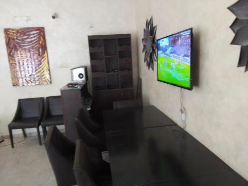 a living room with a tv on a wall at St Theresas apartment Lodge 3 in Lekki