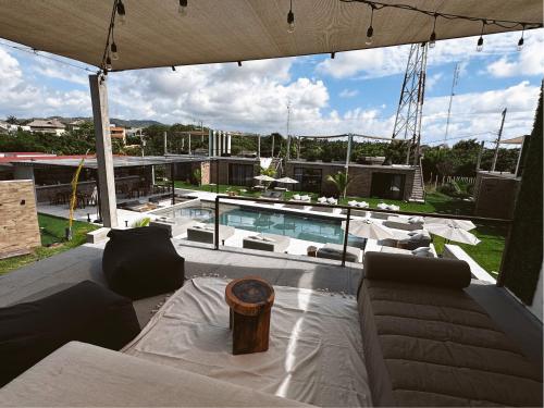 a living room with a couch and a swimming pool at Bora Boutique - Adults Only in Puerto Escondido