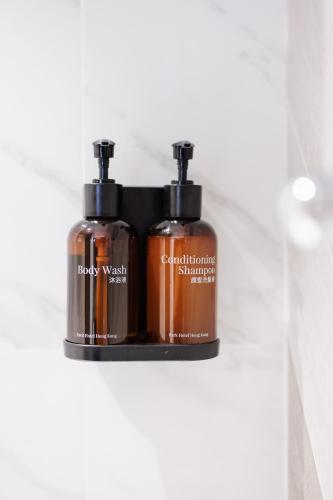 two bottles of soap sitting on a shelf at Park Hotel Hong Kong in Hong Kong