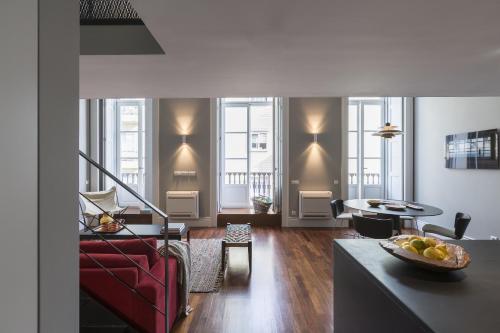 a living room with a red couch and a table at Oporto Serviced Apartments - Cedofeita in Porto