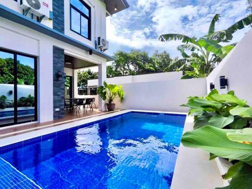 a swimming pool in the backyard of a house at Casa Ysobel, Brand New Villa near Rotunda in Tagaytay
