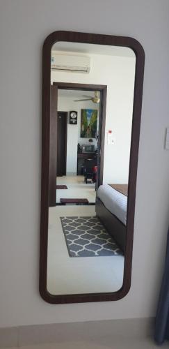 a mirror reflecting a bedroom with a bed in a room at The Dragon Villa Hoi An in Hoi An