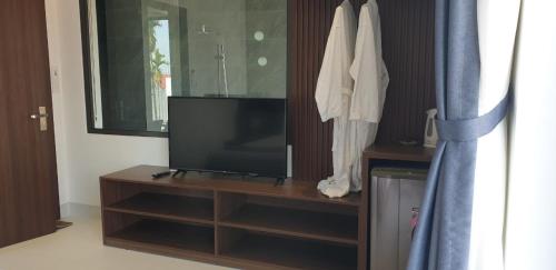 a flat screen tv sitting on top of a wooden entertainment center at The Dragon Villa Hoi An in Hoi An