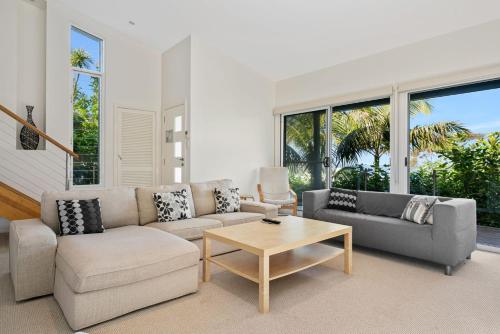 a living room with a couch and a coffee table at Copa Sunset Surprise - Modern and Stylish Simplicity in Copacabana