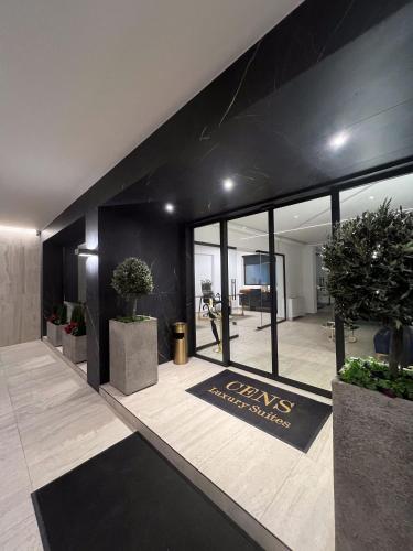 a lobby with potted plants and a sign on the wall at Bronze Suites in Ioannina