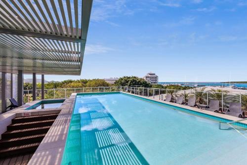 a swimming pool on top of a building at Lux Retreat at Harbour Light Cairns I Sauna I Pool & prime Location in Cairns