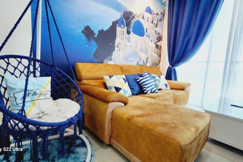 a living room with a couch and a swing at Santorini Holiday Resort Style Staycation 3 rooms in Shah Alam