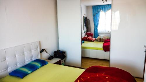 a bedroom with a bed and a mirror in it at Helle, ruhige Dachwohnung in Eningen unter Achalm