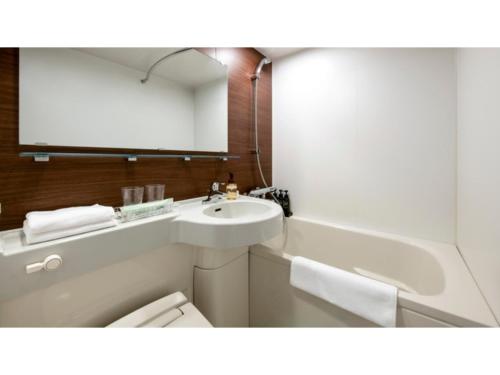 a bathroom with a sink and a toilet and a mirror at Just Sleep Osaka Shinsaibashi - Vacation STAY 94512v in Osaka