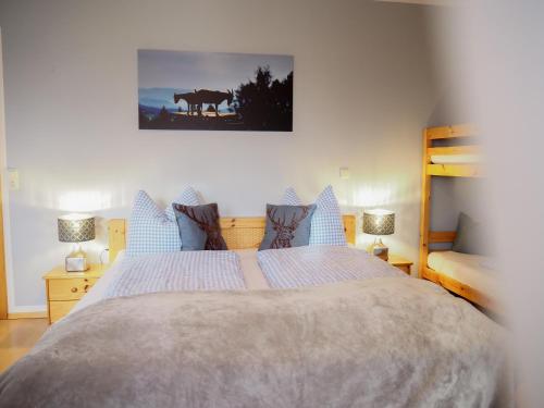 a bedroom with a large bed with blue pillows at ERLEBNISBAUERNHOF Steinerhof in Kärnten in Liebenfels