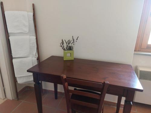 a wooden table with a plant on top of it at BB Convento Sant Antonio di Laurino in Laurino